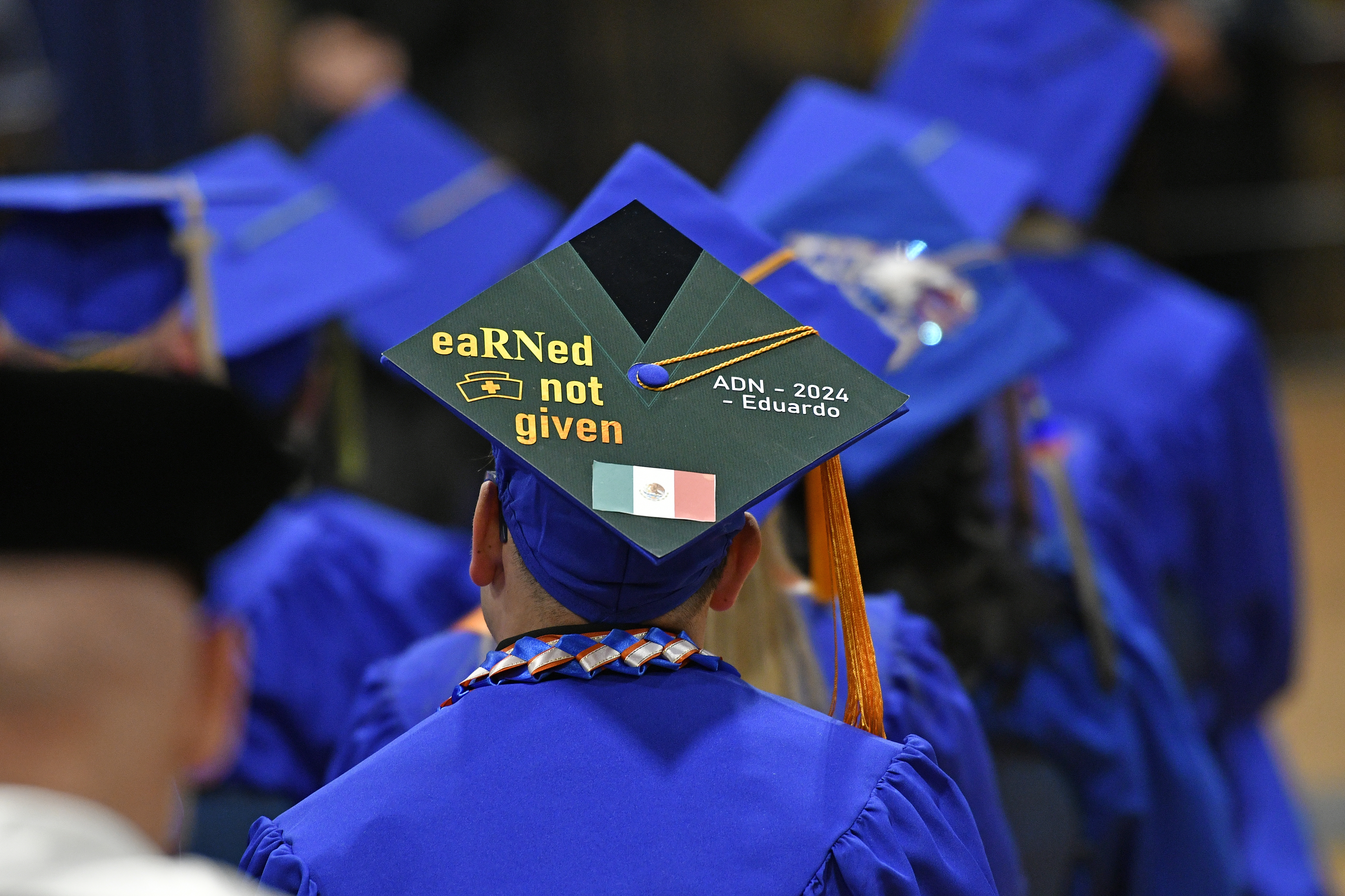 Graduation cap reading "eaRNed not given" ADN 2024 Eduardo